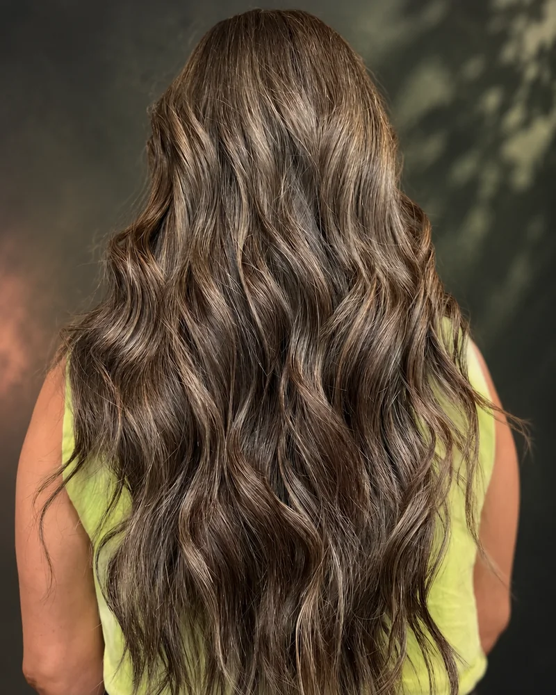Long ashy brunette waves viewed from behind
